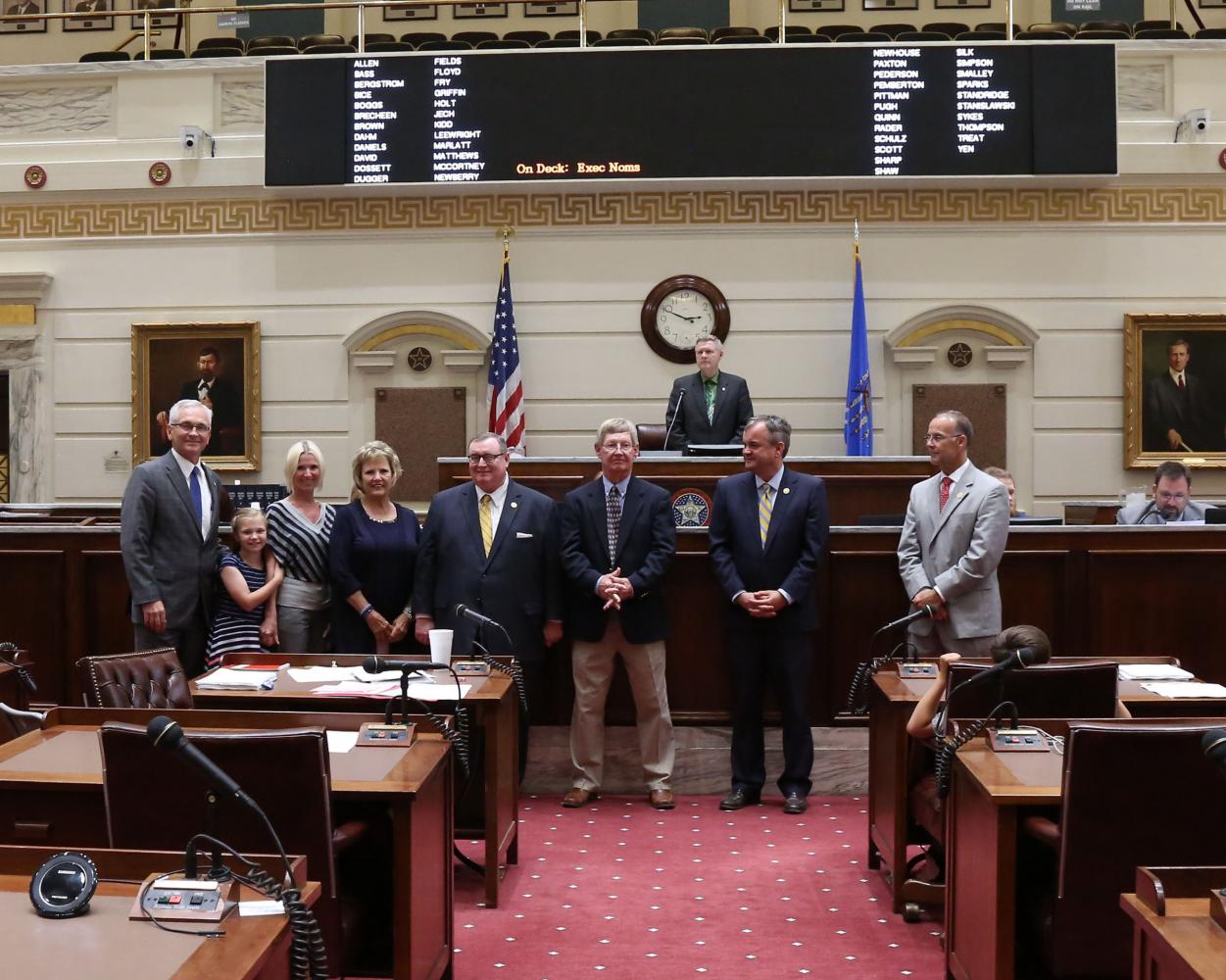 Sen. Darcy Jech, R- Kingfisher (far left) joins SEOSU Coach Mike Metheny (center), SEOSU President, Sean Burrage (2nd from right), SEOSU Athletic Director Keith Baxter (far right) and former SEOSU president and Chancellor of Higher Education Glen D. Johnson (left of Coach Metheny) on the Senate floor at the State Capitol on Tuesday, May 9. Also pictured are Metheny’s wife Pat, daughter Mishael and granddaughter Raini.
