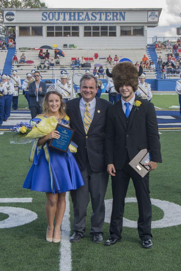 Southeastern president Sean Burrage congratulates Homecoming Queen and King Kayla Castagnetta and Kirk Sanders.