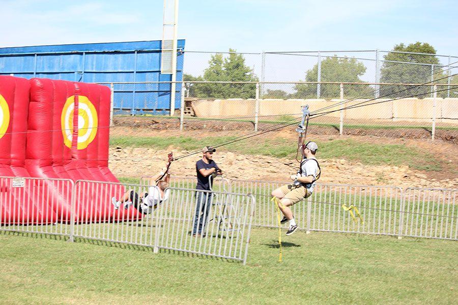 Kane Moore and Brady Henderson make a safe landing at the zip lining event during homecoming week.