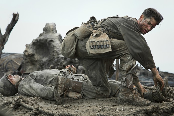 Desmond Doss(Andrew Garfield) coming to the aid of his fellow soldiers. Photo courtesy of moviehole.net.