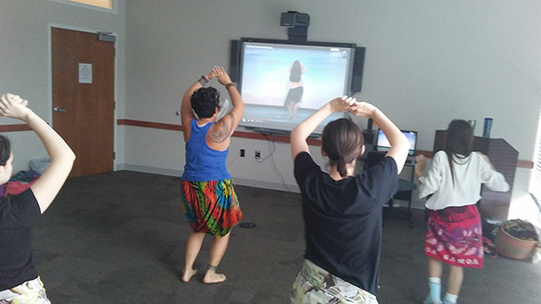 Gingerlei Waddell, Grounds Lands Supervisor, demonstrates Tahitian dance to a class of faculty, staff and students.