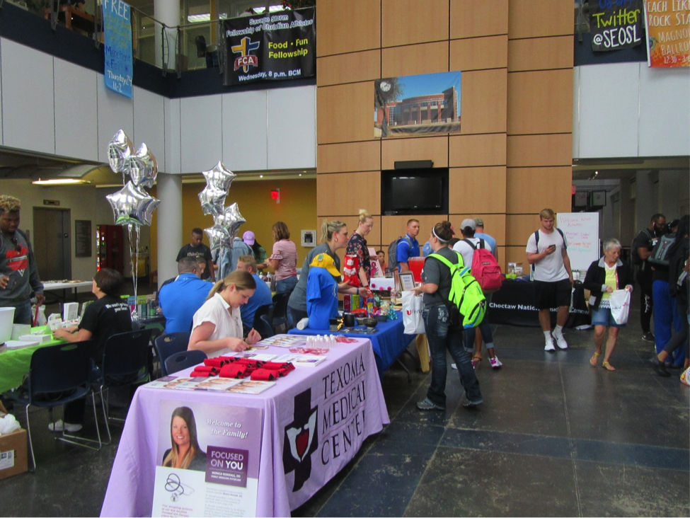 Students and other guests pursue information at booths during the Merchant Fair August 24.