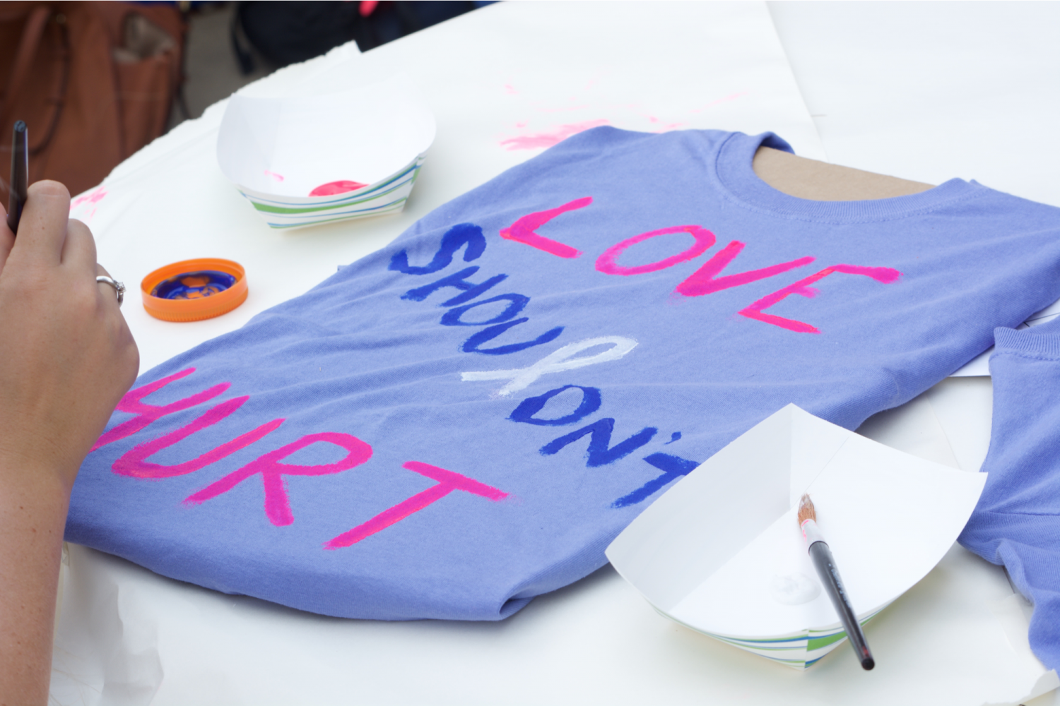 In 2017, students painted T-shirts for the Clothesline Project, a program designed to remind people of the impact of domestic violence.
This year, students are being welcomed back to participate in another t-shirt pinging event: Love.Sex.Lies. on September 25.