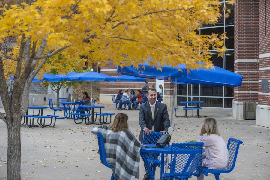 Dr. Kyle Stafford, the Vice President of University Advancement, speaks with prospective students outside of the Student Union between break out sessions. 
