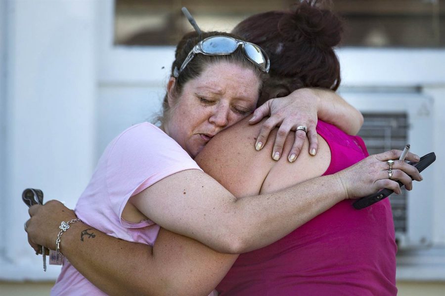 Carrie Matula embraces a woman after a fatal shooting at First Baptist Church in Sutherland Springs, Texas.