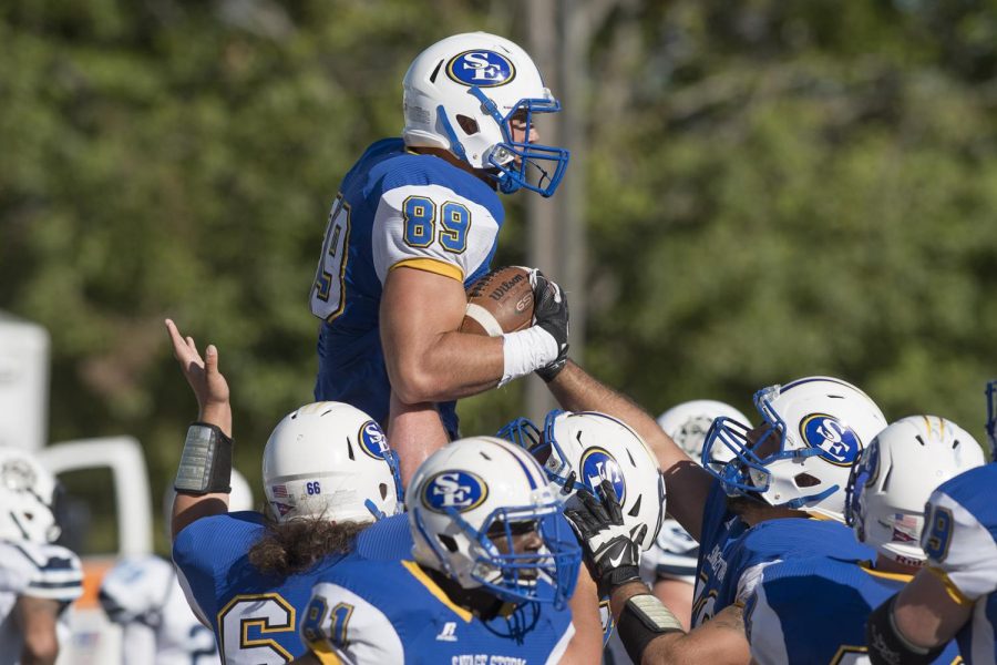 Senior receiver, Codey McElroy, is life into the air as he and fellow teammates celebrate a touchdown during Southeasterns 31-24 victory over Southwestern Oklahoma State University. 