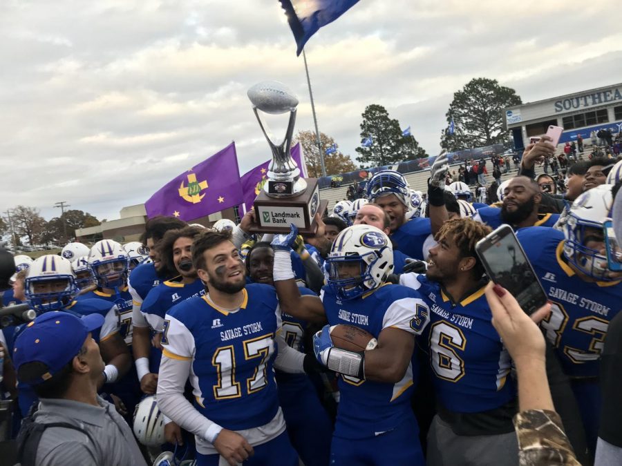 Southeastern players raise new trophy on the field after 27-24 win against ECU Tigers.