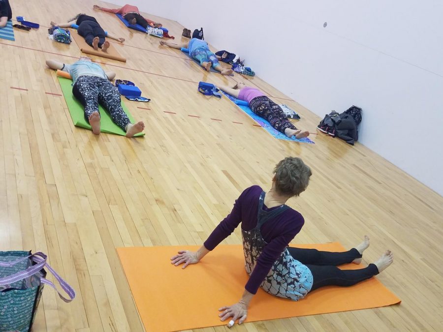 Dr. Jeri Walker(bottom right) conducts a yoga class to for students and faculty. She started the class because, “The mind-breath-body connection... teaches a kinder view of the self. As people let go... space for being true to themselves is opened.”