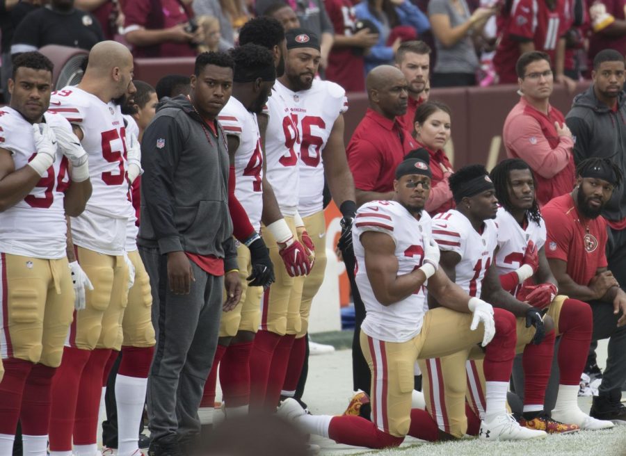 Some members of the San Francisco 49ers kneel during the National Anthem before a game against the Washington Redskins at FedEx Field
https://creativecommons.org/licenses/by-sa/2.0/deed.en