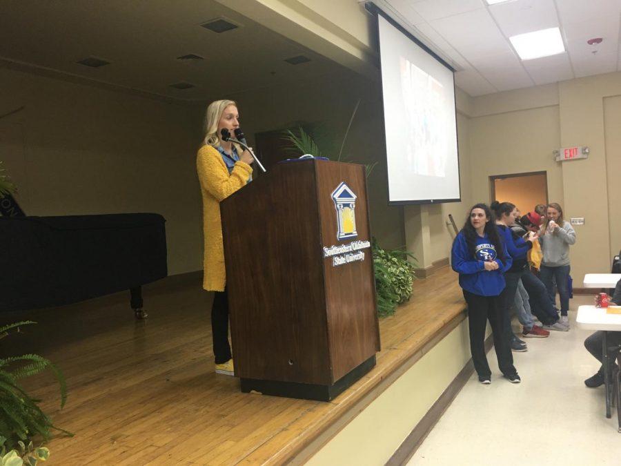 Sarah Hughes of SE recruitment gave out scholarships to incoming SE freshmen as Sarah Lehmann, a Sparks Dance member watched at the right of the stage.