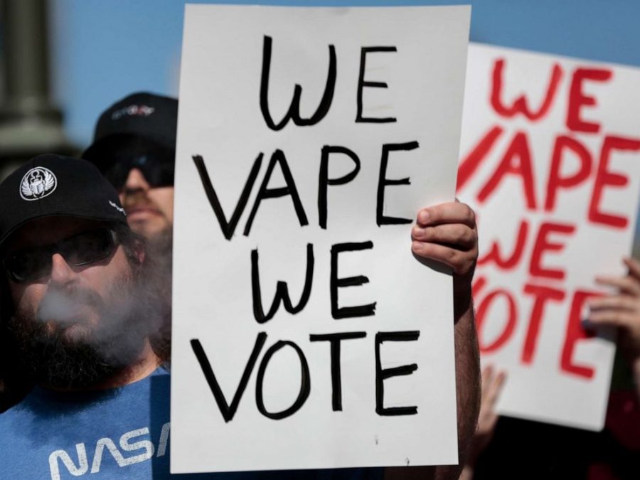 Mark Asbrock, of Fairfield, Ohio, vapes while listening to speakers during a vaping advocates rally, Oct. 1, 2019, at the Ohio Statehouse in Columbus, Ohio.