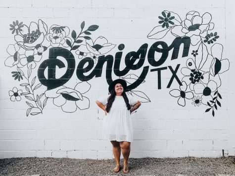 Jenna Zapata stands proudly with the freshly painted mural on the side of Zig Zag Galleries. Visitors are welcome to hop on back to snap photos of their own.