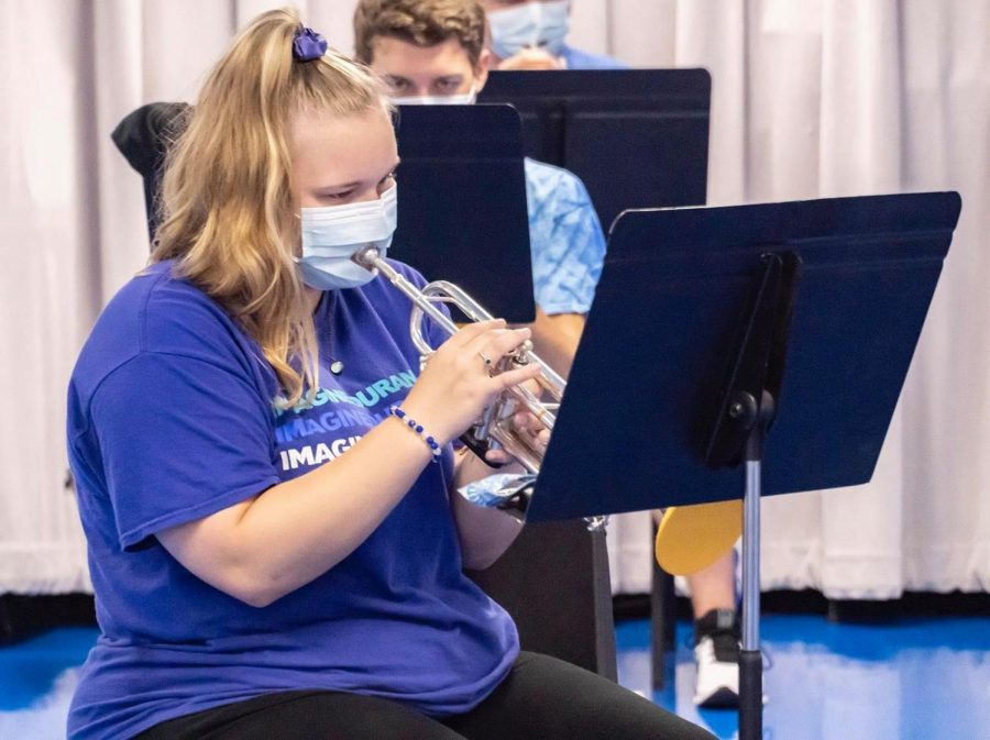 Kelsie Cook, sophomore and trumpet player, practices indoors with her bell cover customized mask.