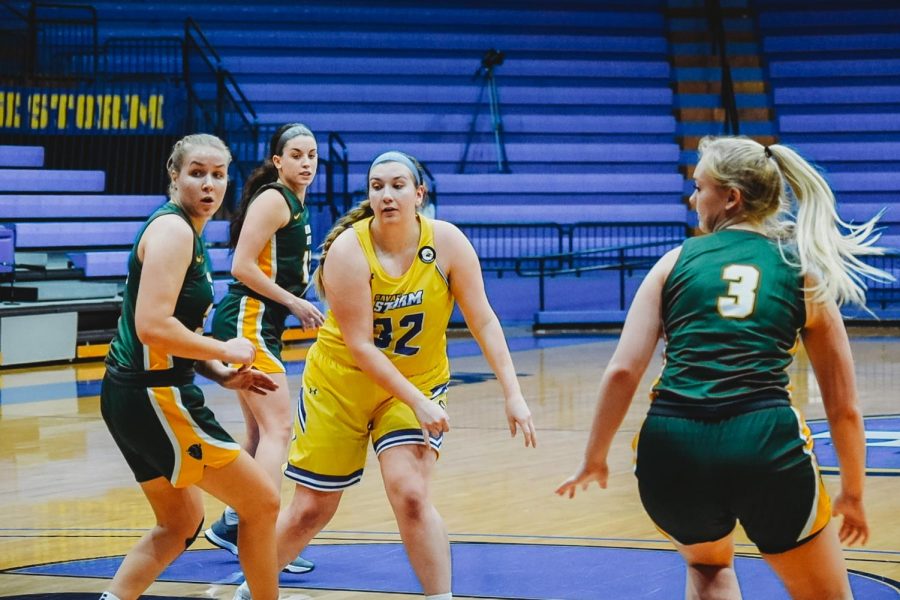 Katie Branam, senior chemistry major, surrounded by OBU players on Jan. 23. 