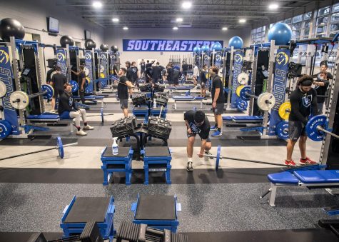 Athletes work out in the new weight room.