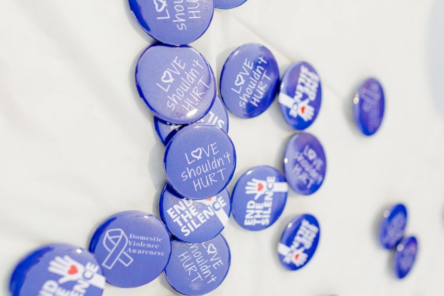Buttons were passed out as reminders that love shouldn't hurt and we must band together to end the silence on domestic violence.